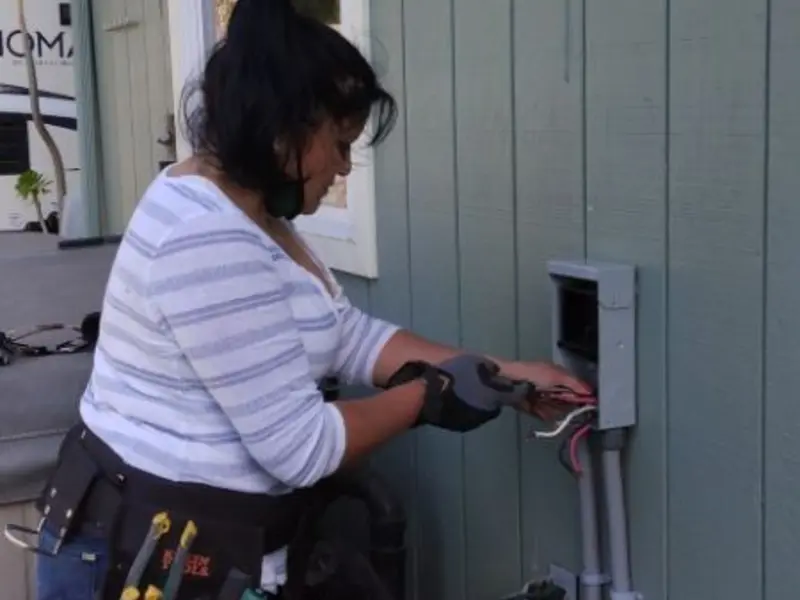 Licensed electrician wiring an exterior subpanel in Sacramento